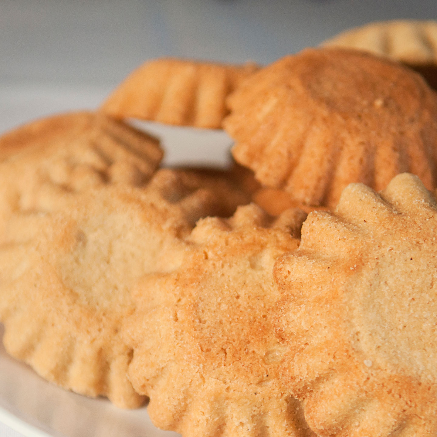Golden baked cookies on white plate