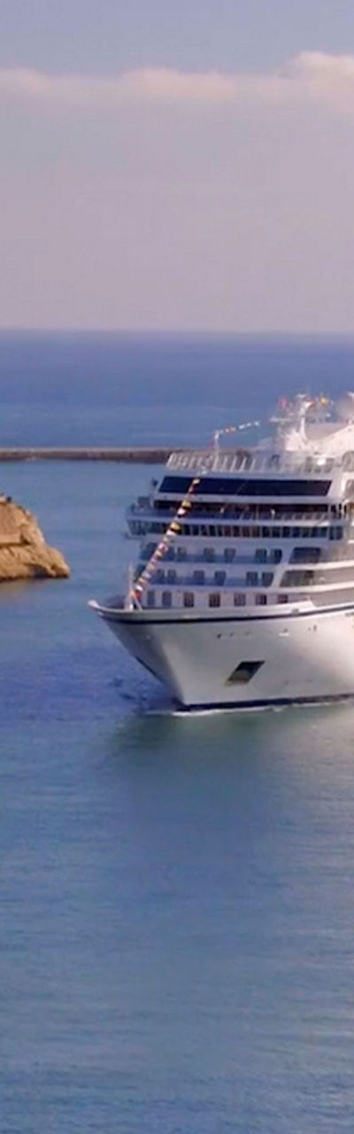 Luxury cruise ship in scenic harbor