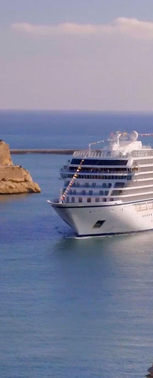 Luxury cruise ship in scenic harbor