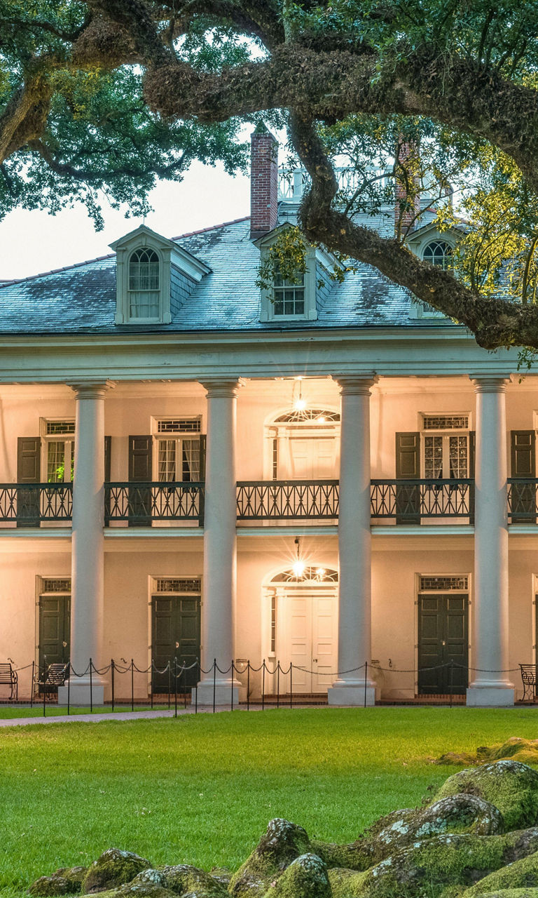 Historic mansion surrounded by oak trees