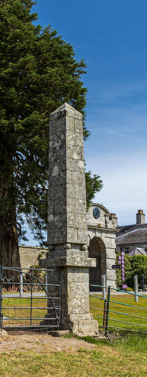 Historic estate with stone pillars and greenery