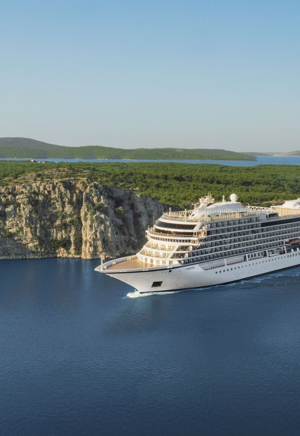 Luxury cruise ship sailing scenic coastline