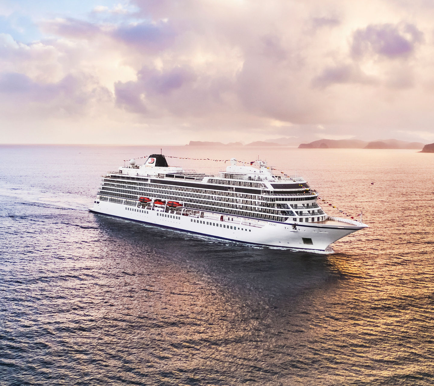 Luxury cruise ship sailing at sunset