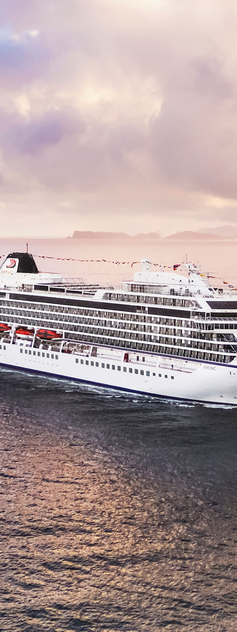 Luxury cruise ship sailing at sunset