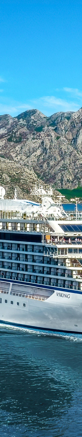 Luxury cruise ship sailing in scenic fjord