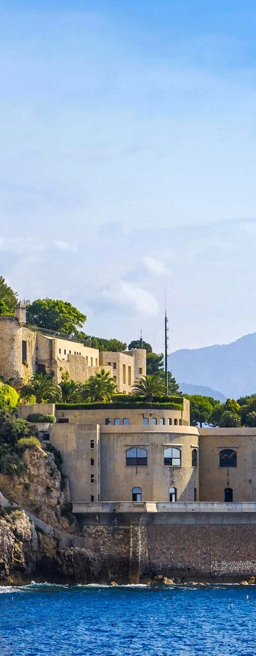 Historic cliffside building overlooking the sea