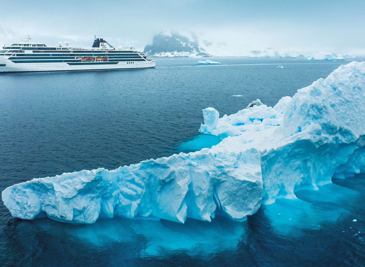 Cruise ship near iceberg in Arctic waters