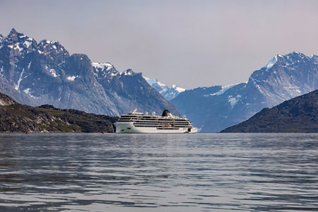 Cruise Ship Sailing Through Mountainous Fjord Landscape
