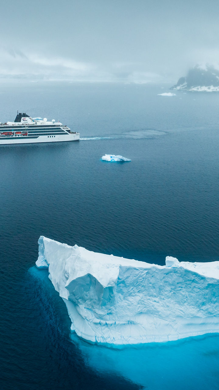 Cruise ship near iceberg in Arctic waters