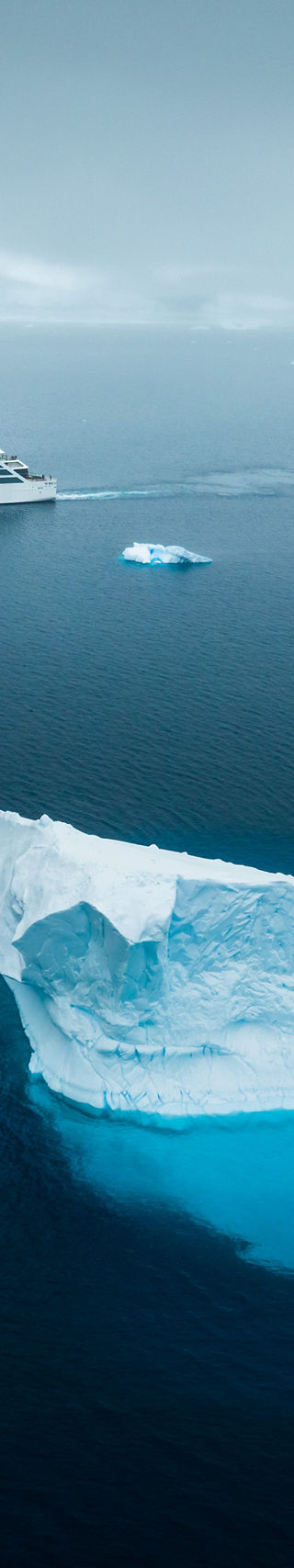 Cruise ship near iceberg in Arctic waters