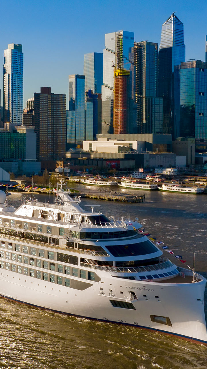 Luxury cruise ship near city skyline