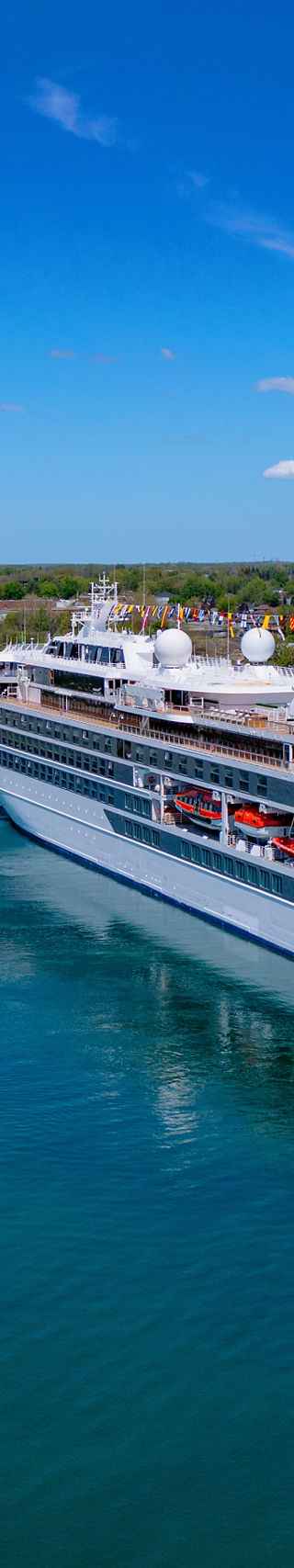 Luxury cruise ship sailing through canal