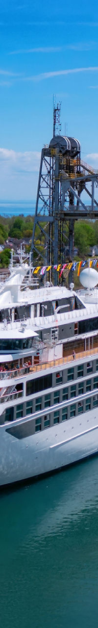 Luxury cruise ship passing through canal bridge