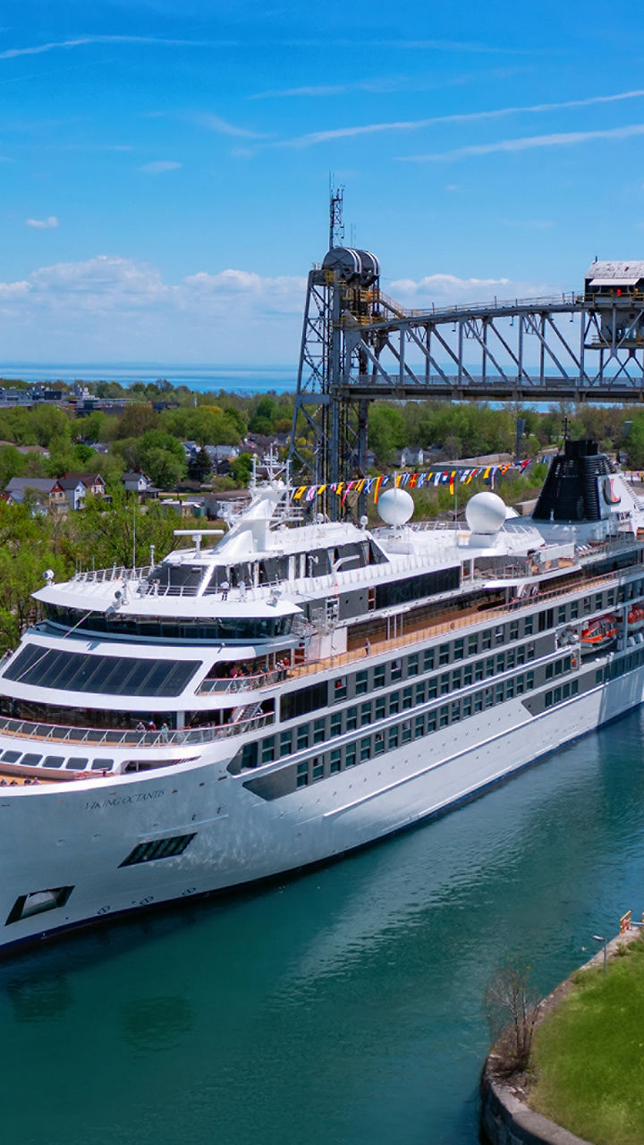 Luxury cruise ship passing through canal bridge