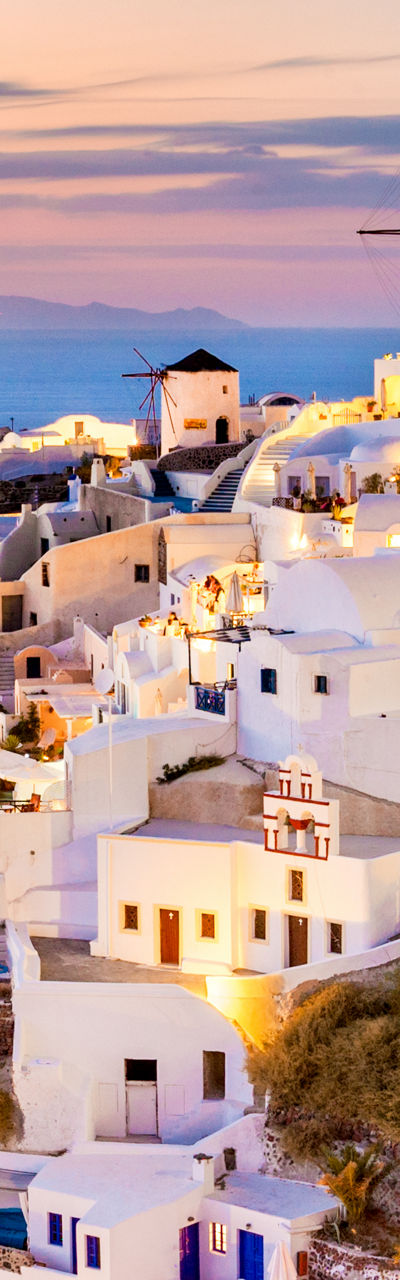 Santorini village at sunset with glowing lights