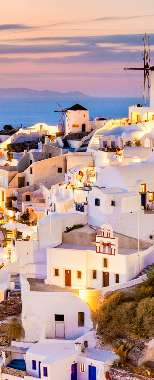Santorini village at sunset with glowing lights