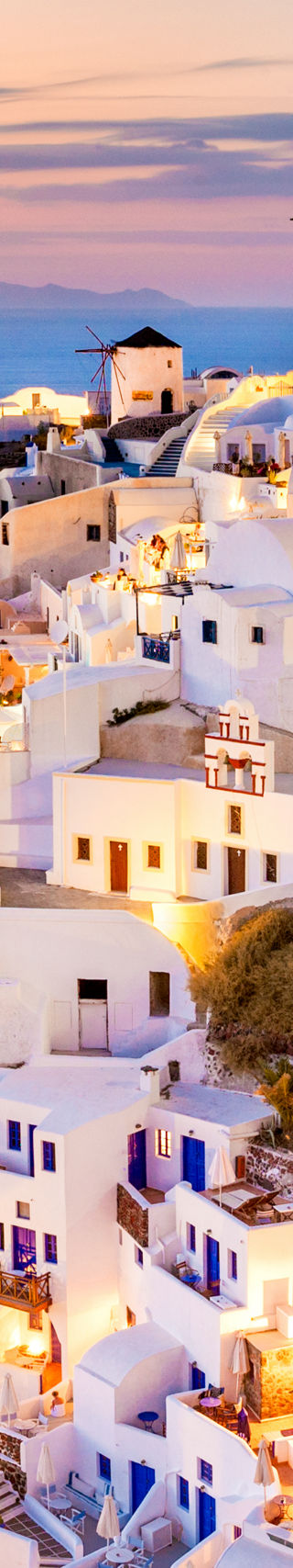 Santorini village at sunset with glowing lights