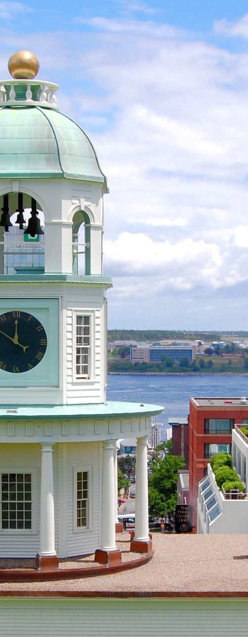 Historic clock tower overlooking waterfront cityscape