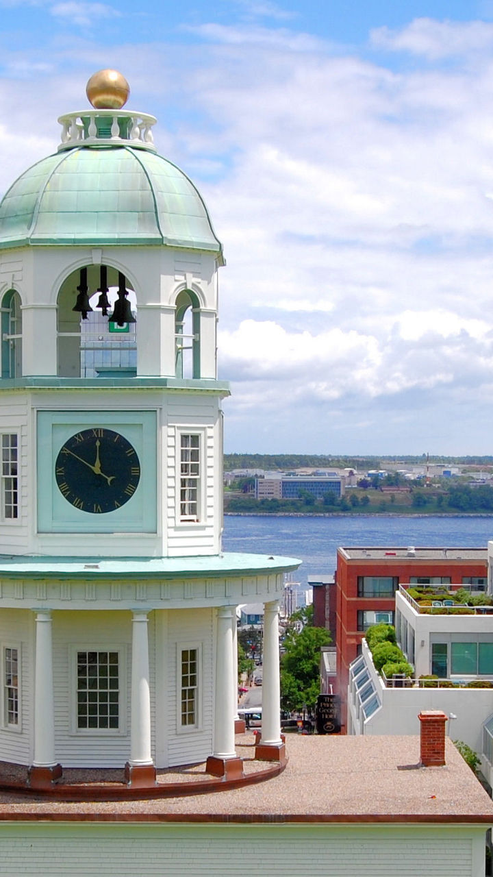Historic clock tower overlooking waterfront cityscape