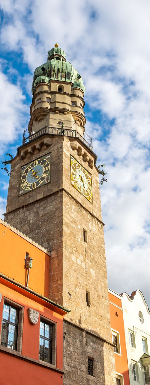 Historic clock tower in colorful cityscape