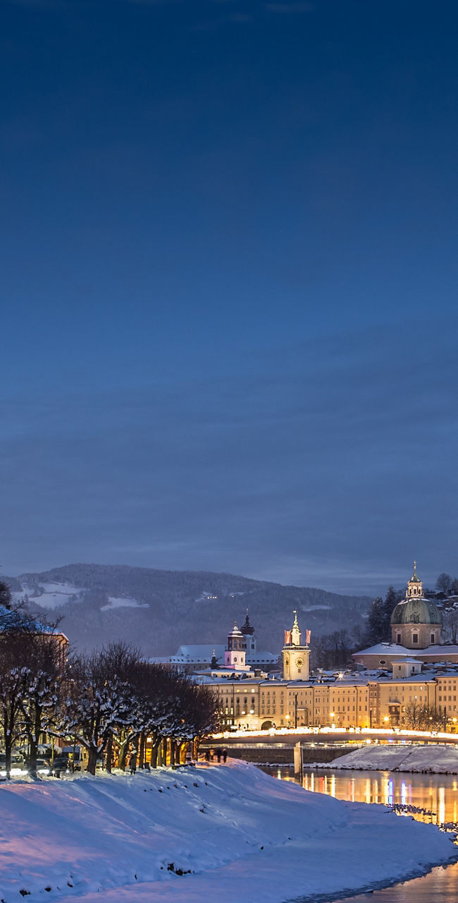 Snowy Salzburg cityscape at twilight