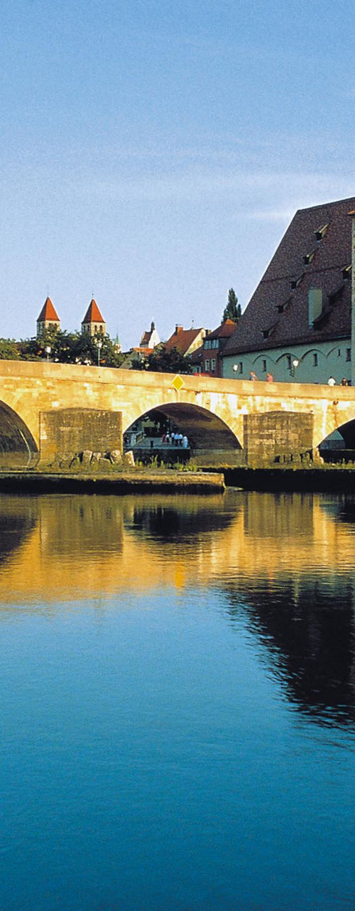 Historic stone bridge and cathedral reflection