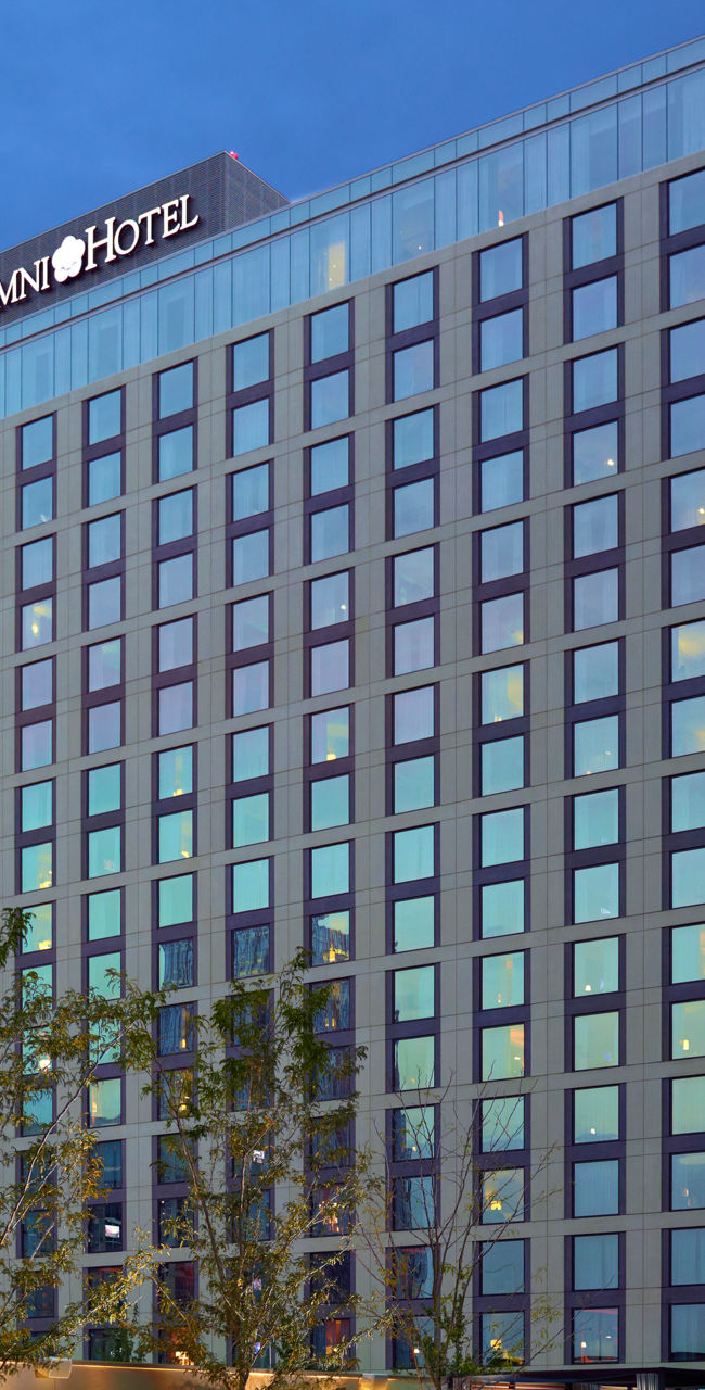 Modern hotel with outdoor pool at sunset