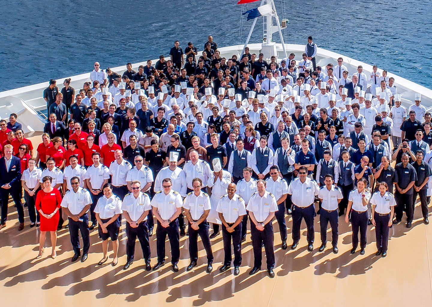 Group photo on cruise ship with scenic backdrop