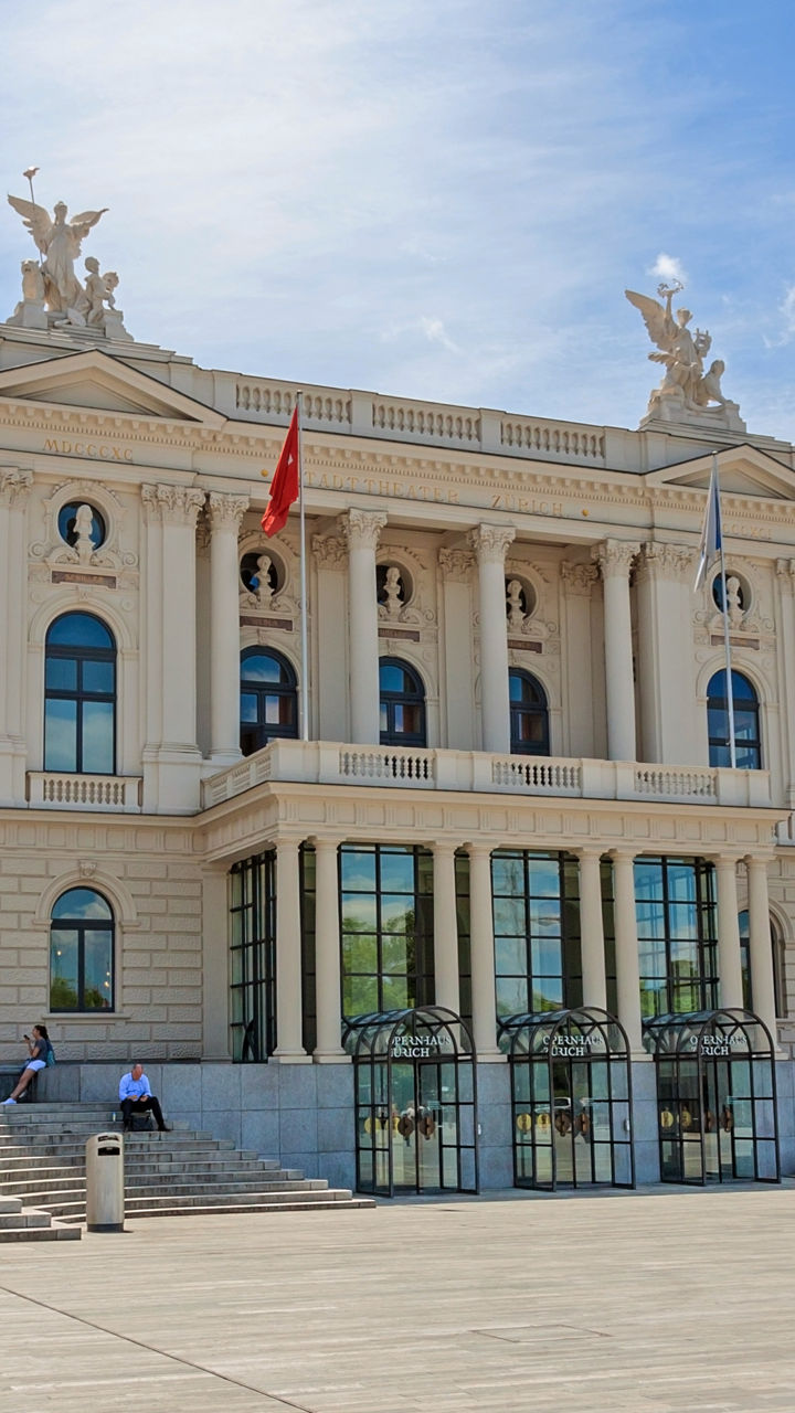 Historic building with open plaza under blue sky