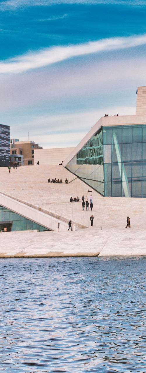 Modern waterfront architecture under vibrant sky