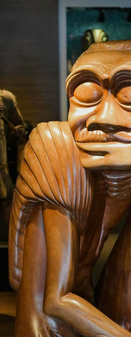 Wooden figurative sculptures in museum gallery