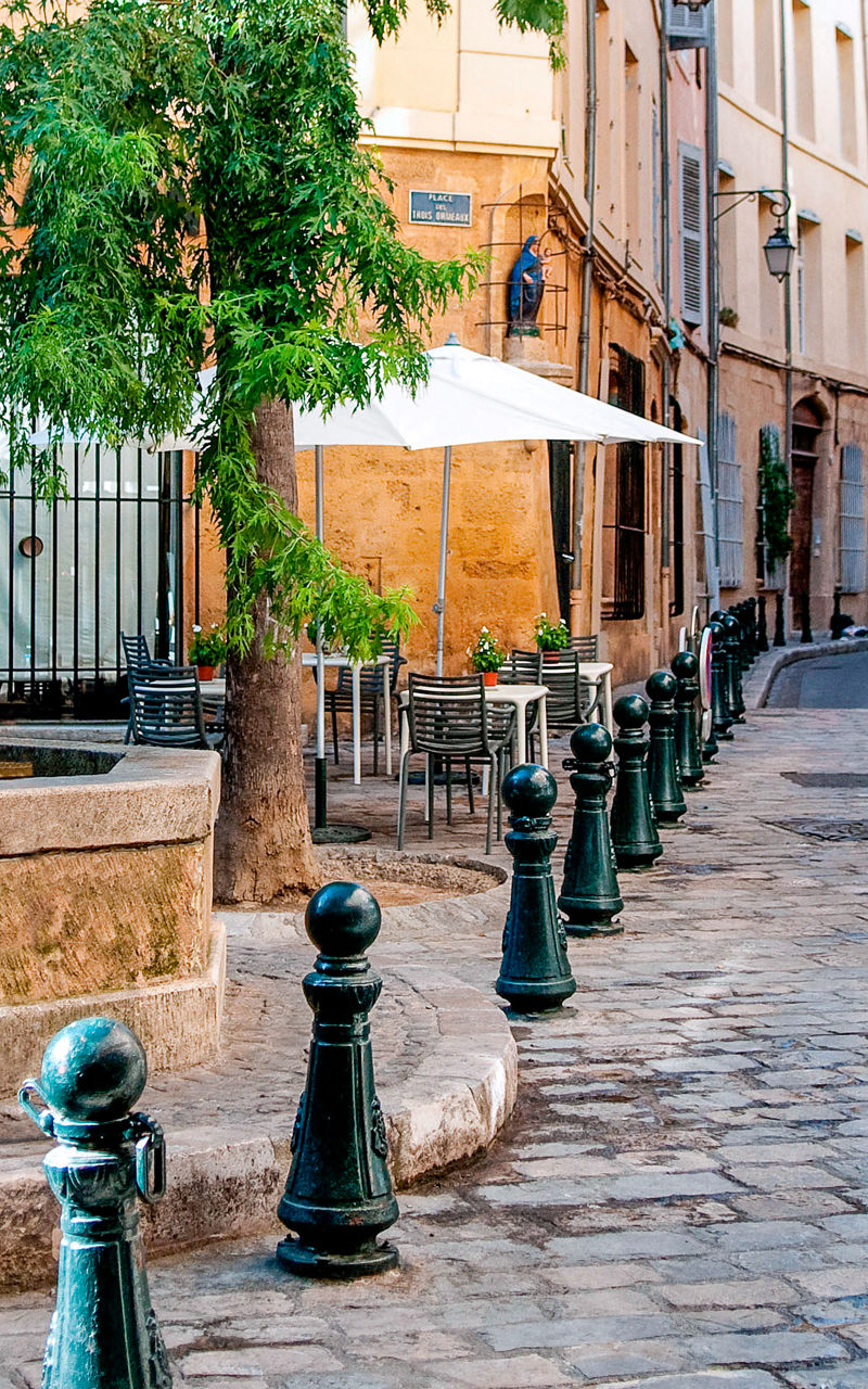 Charming European street with stone fountain