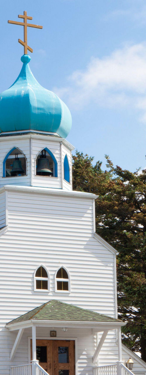 White church with blue domes and crosses