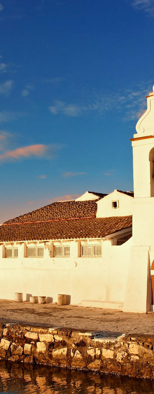 White coastal chapel at sunset