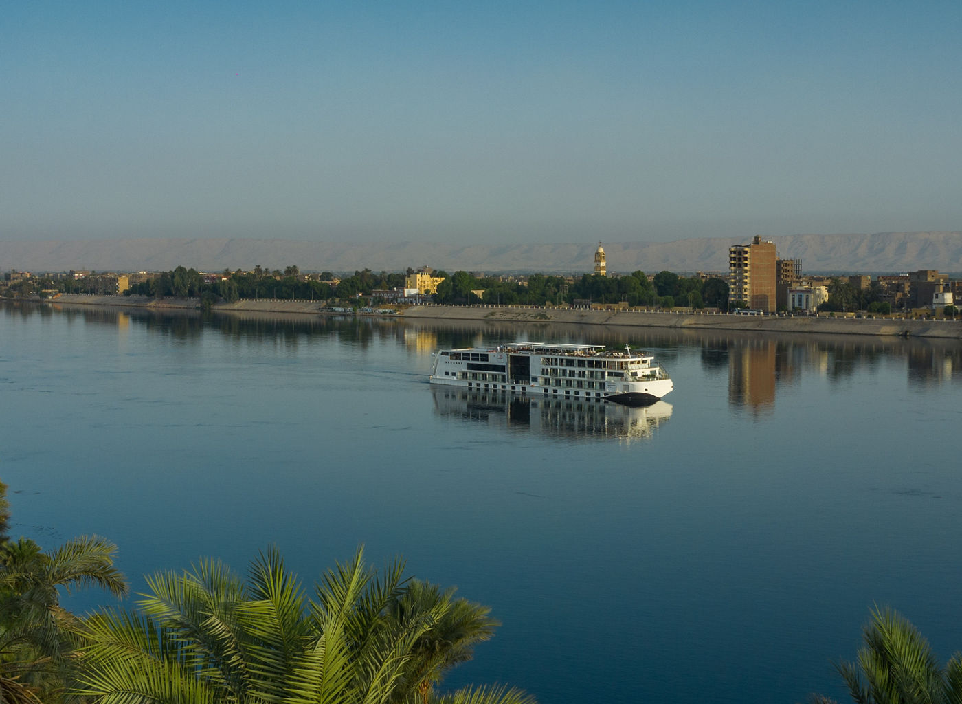 Cruise ship on serene Nile River landscape