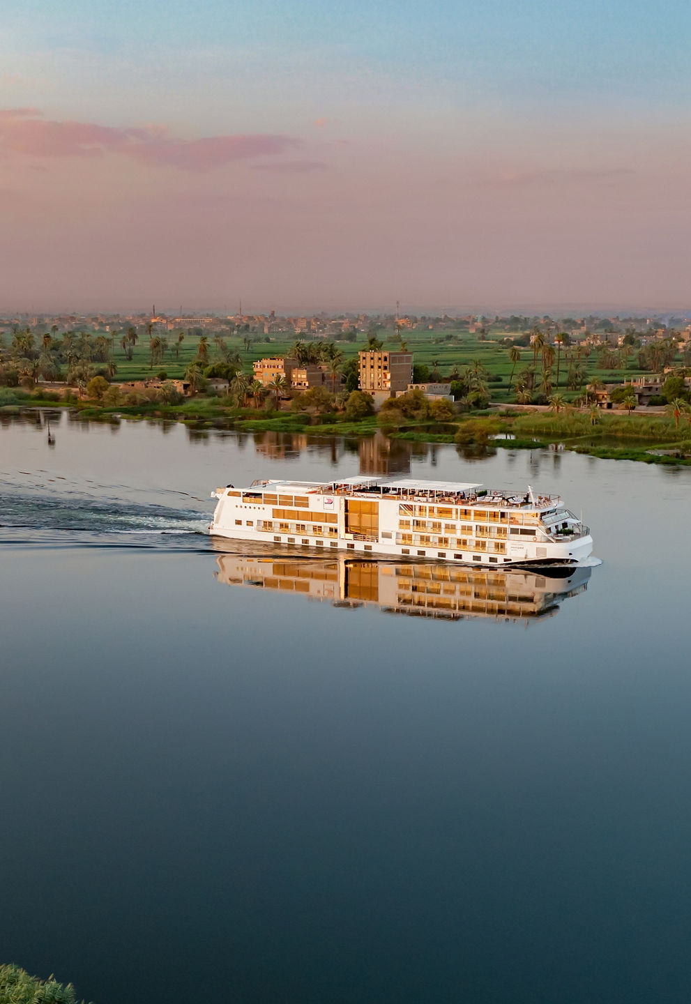 River cruise ship sailing at sunset