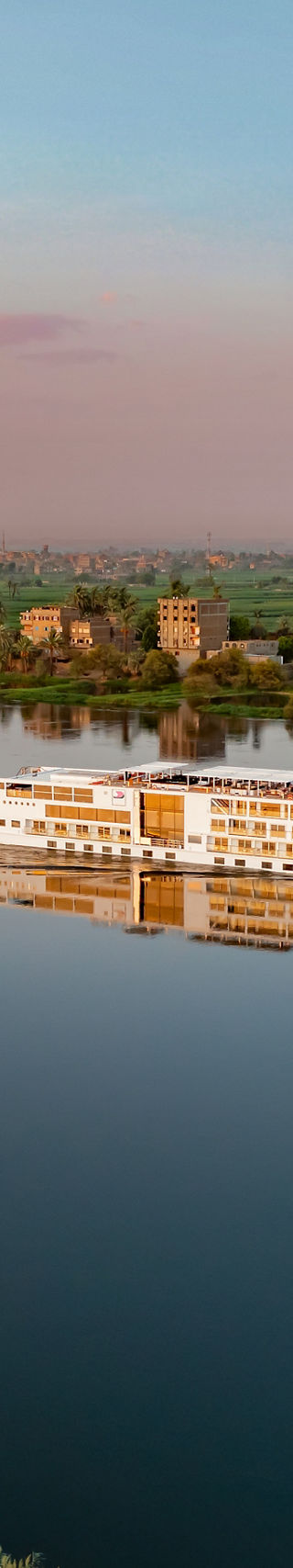 River cruise ship sailing at sunset