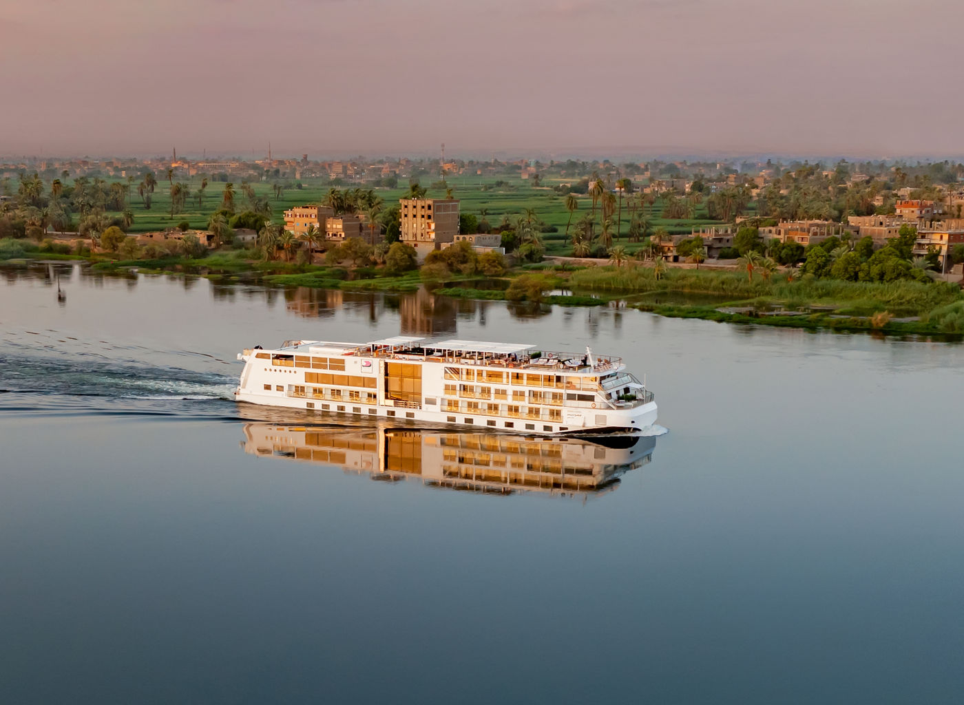 River cruise ship sailing at sunset