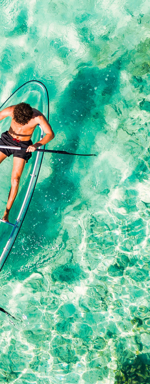 Two people kayaking in crystal-clear water