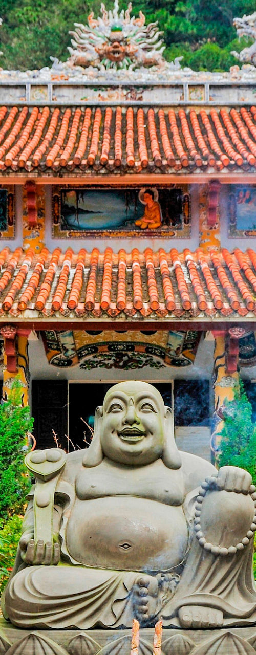 Traditional Buddhist temple with statue and incense