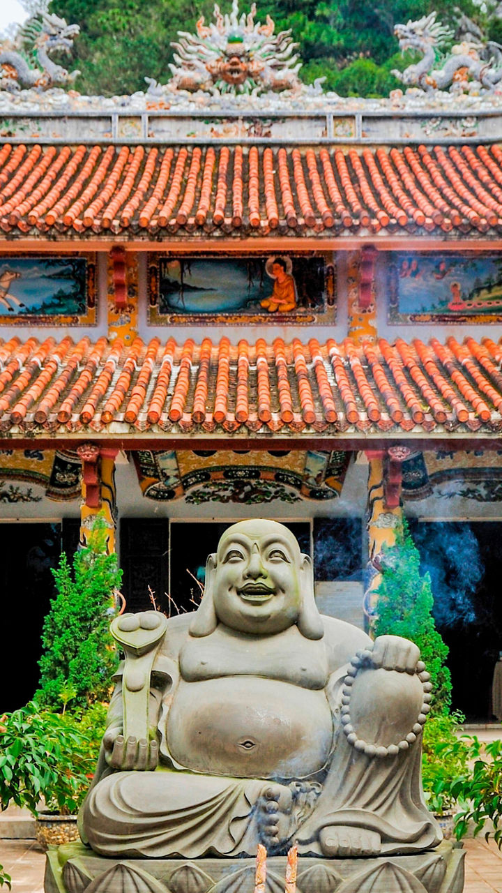 Traditional Buddhist temple with statue and incense