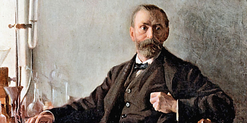 Bearded gentleman seated in laboratory interior