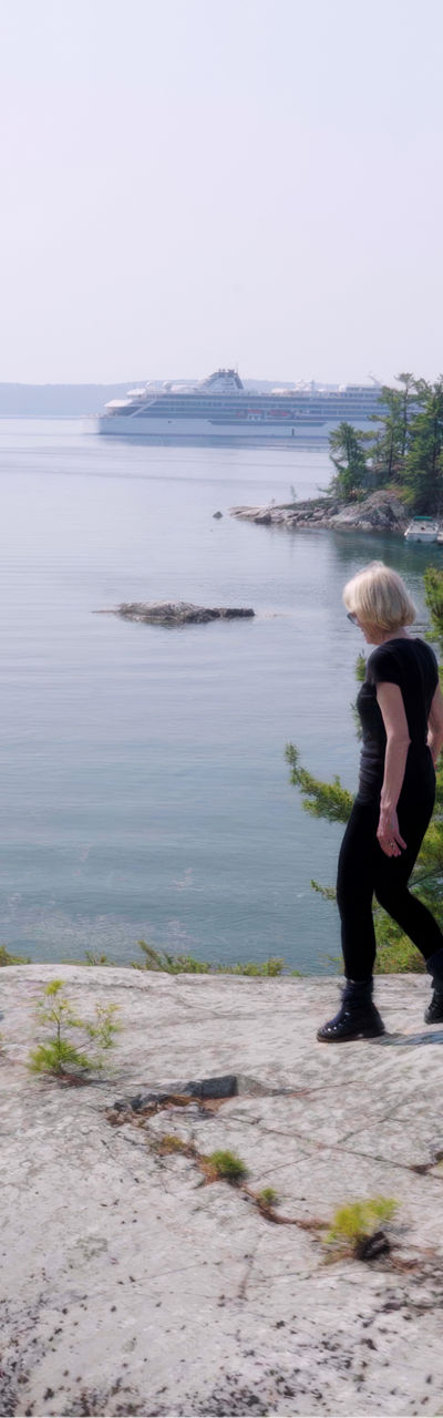 Two hikers explore scenic lakeside cliffs