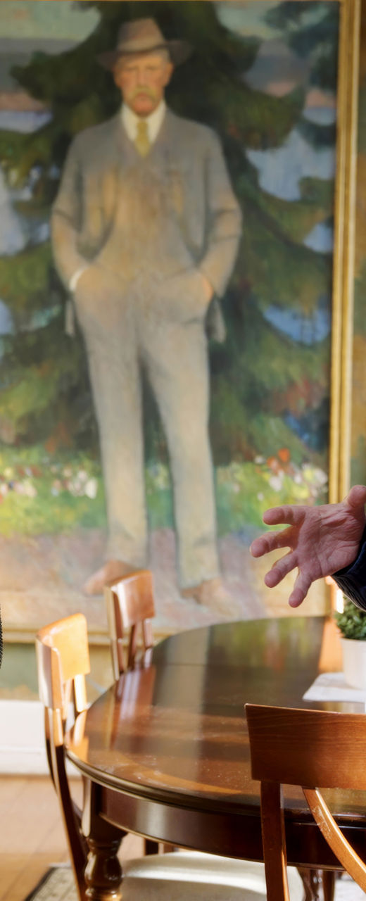 Two men discussing in art-filled room
