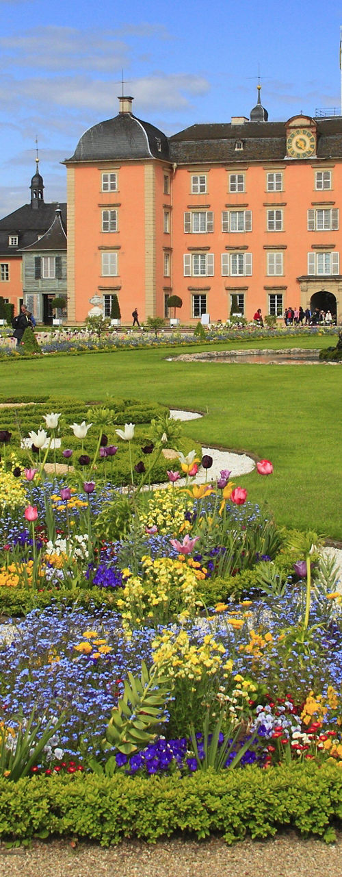 Historic palace with vibrant flower garden