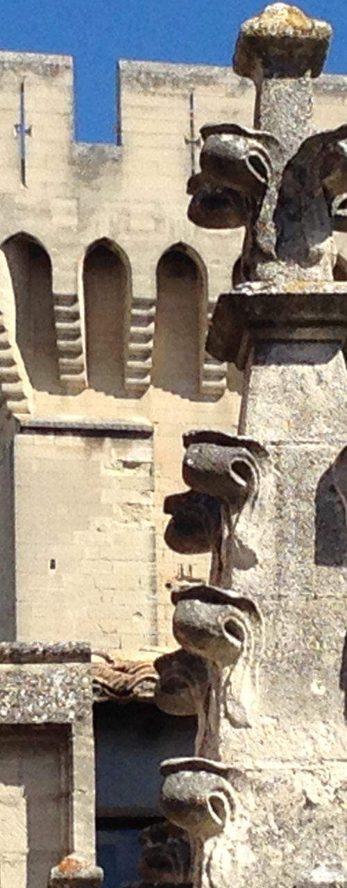 Historic stone architecture with golden statue