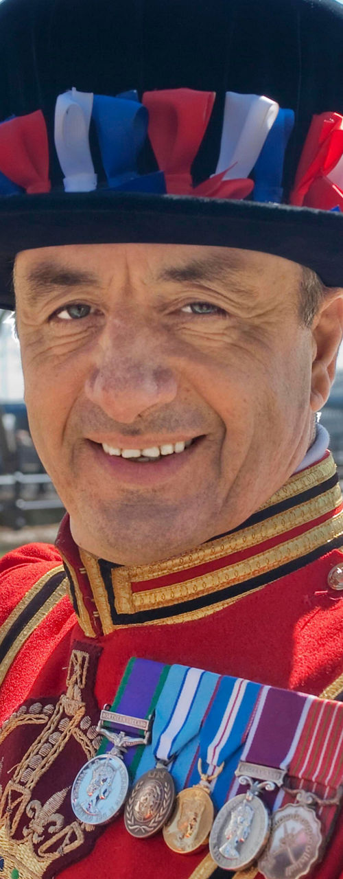 Beefeater in traditional uniform near Tower Bridge