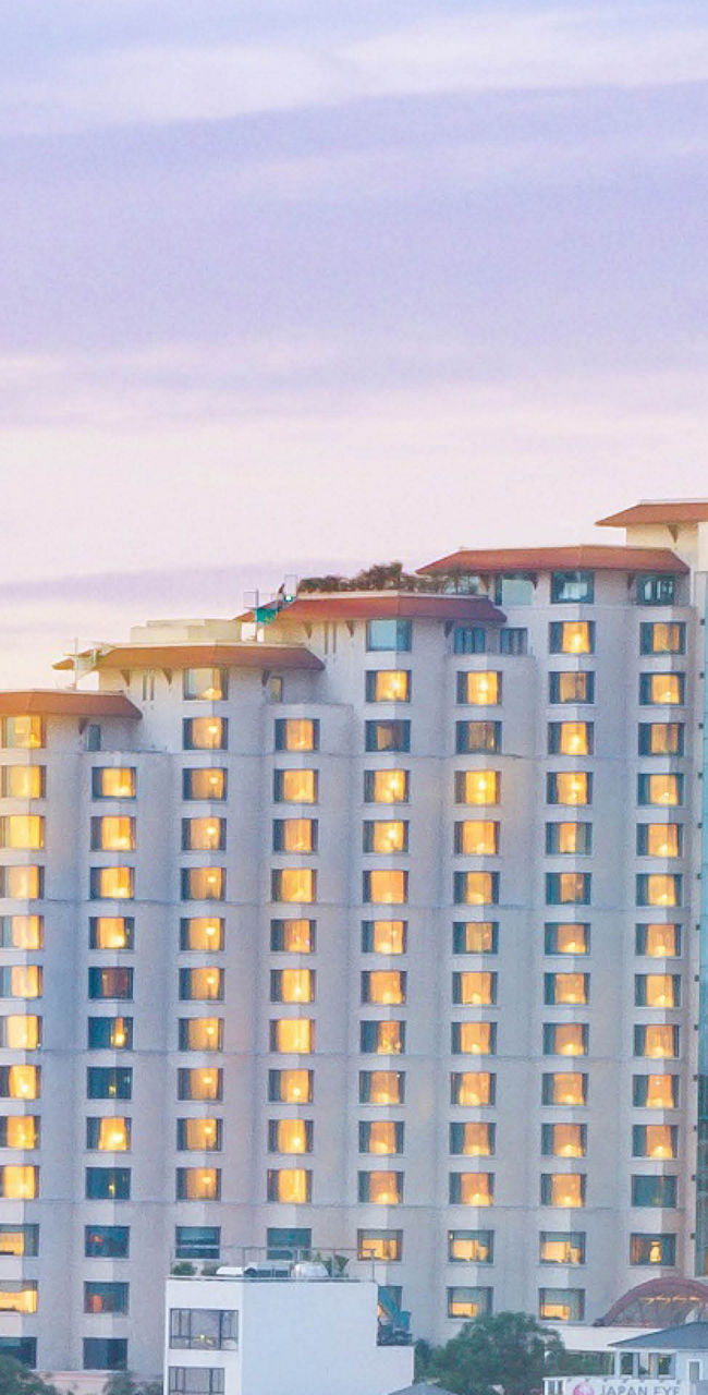 High-rise hotel at sunset in urban cityscape