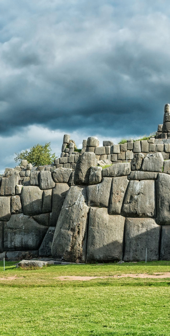 Ancient Stone Wall Under Cloudy Sky