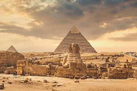 Panoramic view of Giza pyramids at sunset